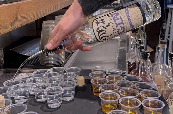 Tour and Tasting at Striped Pig Distillery - Choosing between espresso vodka, pecan bourbon, and classic bourbon